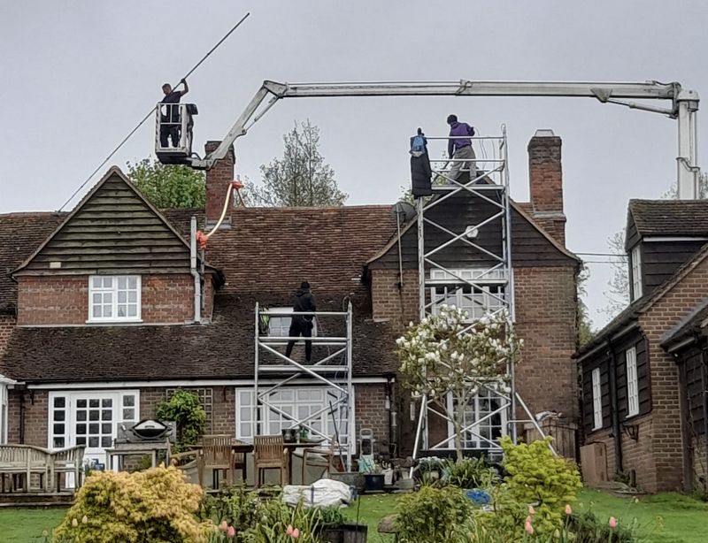 The Roof Moss Cleaners using cherry picker and scaffolding to clean roof safely and professionally in East Grinstead, West Sussex